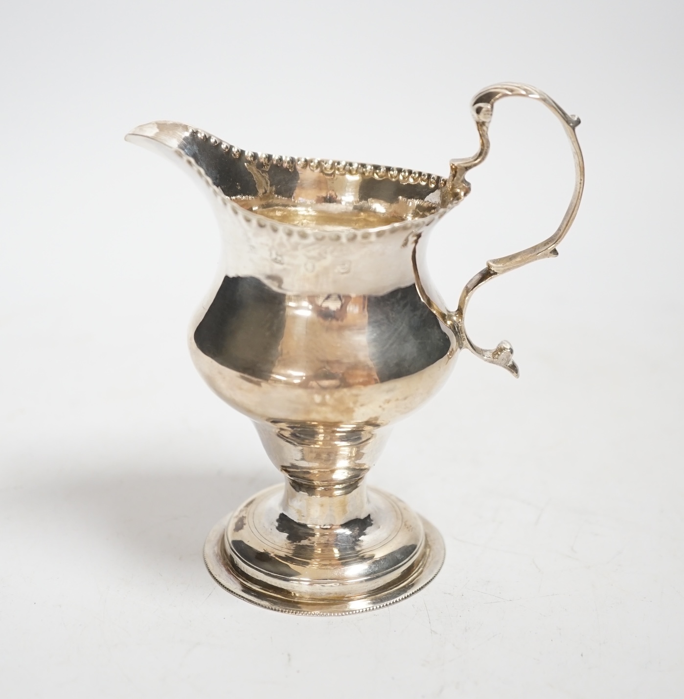 A George III silver inverted pear shaped cream jug, by Charles Hougham, London, 1780, 11.5cm, 2.4oz.